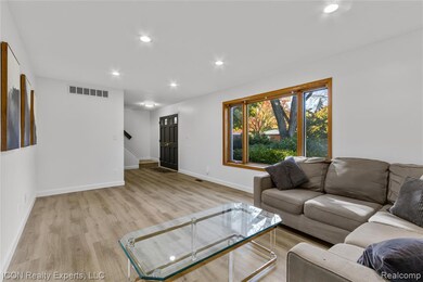Living room with recessed lighting and light wood-style flooring
