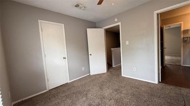 Unfurnished bedroom featuring ceiling fan, carpet,