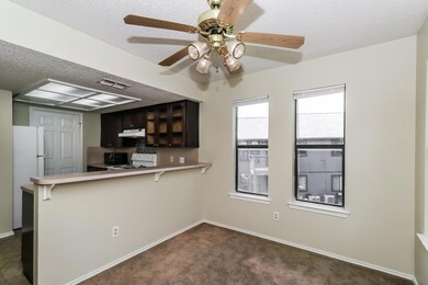 Kitchen featuring white appliances, under cabinet