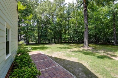 Brick walkway from garage into backyard.