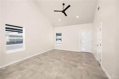 Spare room featuring high vaulted ceiling, recessed lighting, and ceiling fan