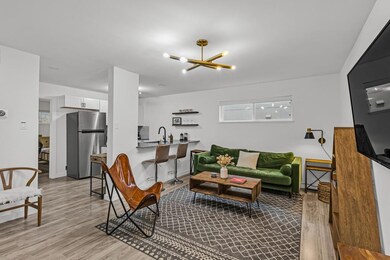 Living area with a chandelier and light wood-type