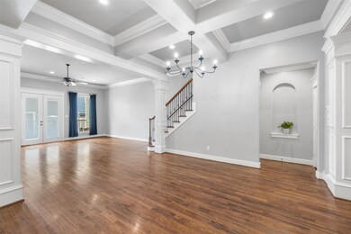 This spacious living area features elegant hardwoo