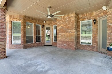 View of back patio with a ceiling fan