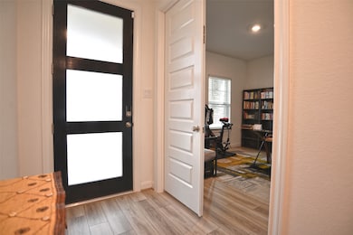 Entry with fancy door and double doors to office