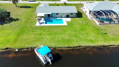View of pool and canal showing boating lifestyle in Rotonda West