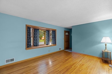 Living room with hard wood floors and bay style window!