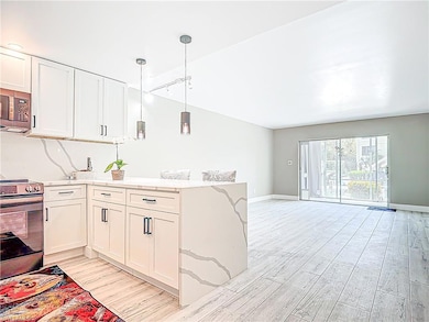 Kitchen with open floor plan, a peninsula, white c
