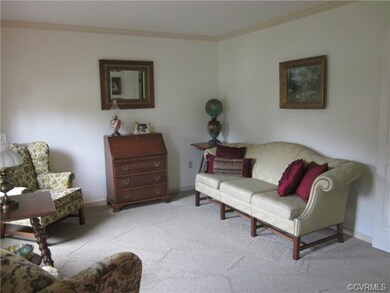 Living room leads into family room by way of frenc