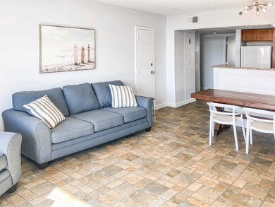 Living room featuring a chandelier and tile patter