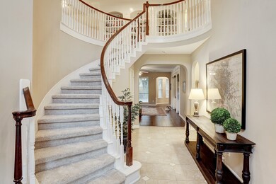 A two-story foyer with a sweeping staircase draws you inside, with an office to the right and formal dining room to the left.