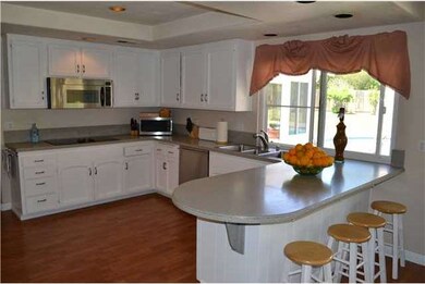 The kitchen offers recessed lighting, corian type 