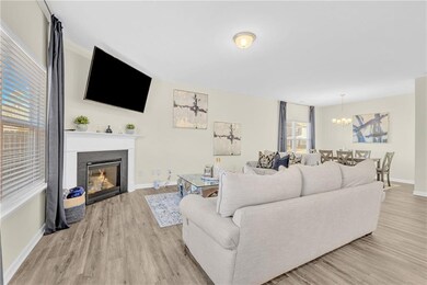 Living room with light hardwood / wood-style floor