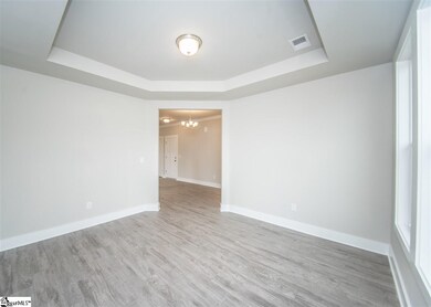 Off the entry, a formal living room space can also