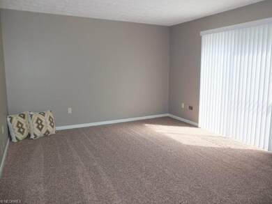 Family room with new carpet and access to patio.