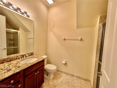 Bathroom featuring vanity, toilet, and tile patterned floors
