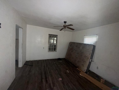 Spare room with dark wood finished floors and ceiling fan