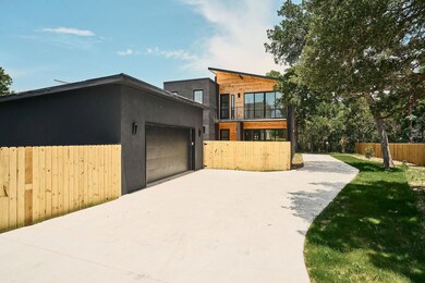 Contemporary house with concrete driveway and a g