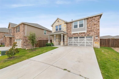 Traditional-style house featuring driveway, stone