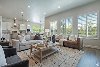 Living room featuring recessed lighting, wood finished floors, and a textured ceiling