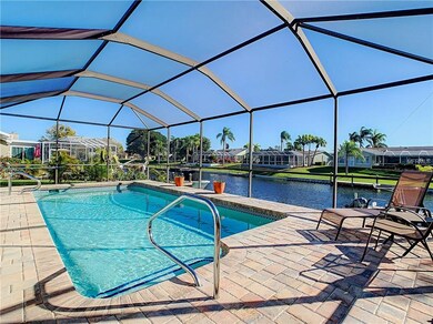 Pool and paver deck inside screened enclosure.