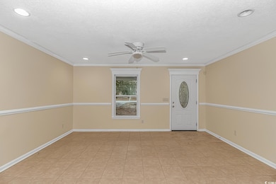 Foyer entrance with a textured ceiling, ceiling fa