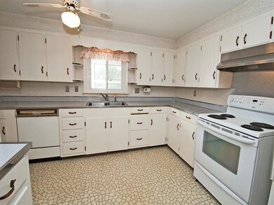 White kitchen has an abundance of cabinets