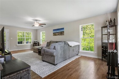 Living room featuring wood-type flooring, plenty o