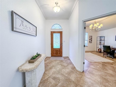 Foyer with ornamental molding, plenty of natural 