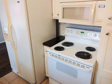 Kitchen with white appliances and white cabinetry