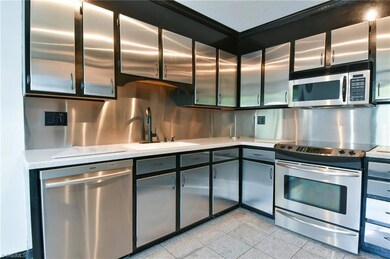 1620 Windsong kitchen w/ marble tile floor, stainless steel cabinets & solid surface countertops