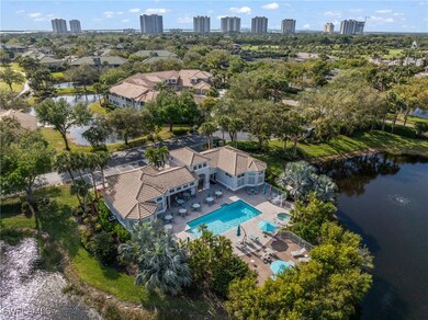 Drone / aerial view of a pool and a nearby body of