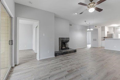 Unfurnished living room with a ceiling fan, light