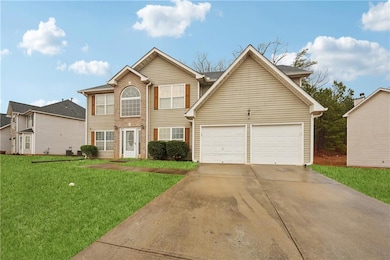 View of front of house with a garage, brick siding