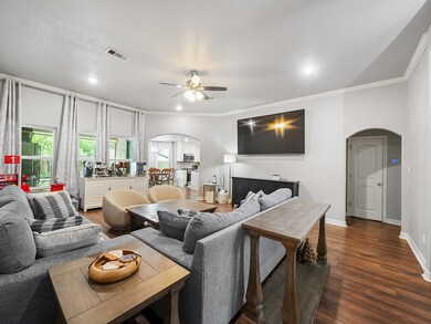 THIS ANGLE OF THE LIVING ROOM SHOWS THE KITCHEN TO