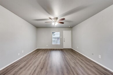 Unfurnished room with ceiling fan and light hardwood / wood-style flooring