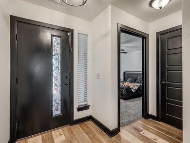 Entryway with baseboards and light wood-style floors