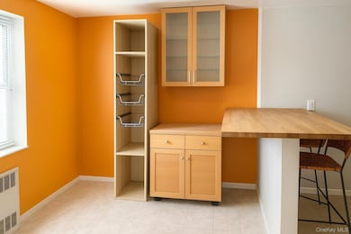 Kitchen featuring wood counters, a kitchen breakfast bar. AI enhanced.