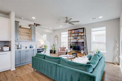 Living area featuring bar, light wood-style floor