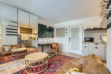 Living room with light wood-style floors and a wa