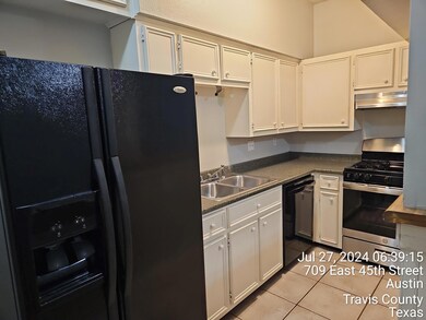 Kitchen featuring black appliances, a sink, dark 