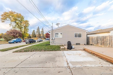 Back of house with a wooden deck and a patio area