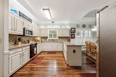 Spacious kitchen with granite counters and peninsula, new microwave, dishwasher and garbage disposal. Laminate flooring. Above cabinet lighting.