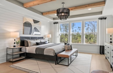 Bedroom featuring light wood-style floors, beam ceiling, and wooden walls