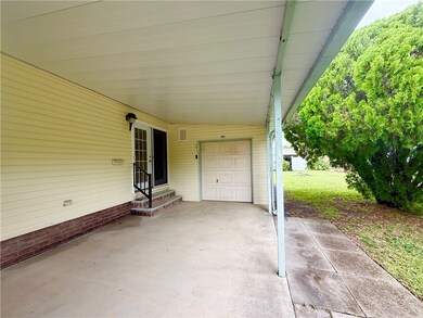 View of patio featuring entry steps and a carport