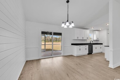 Kitchen featuring dishwasher, white cabinetry, pen