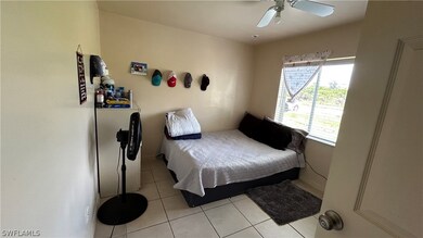 Tiled bedroom with ceiling fan