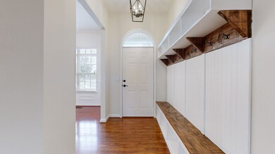 Inviting foyer with custom built-in hall tree.