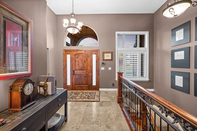 Foyer featuring a chandelier and a towering ceiling