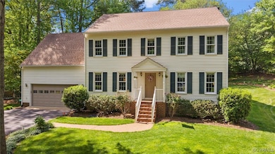 Colonial home with concrete driveway, an attached